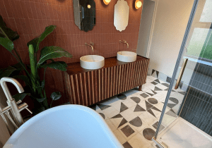 Luxury bathroom in Huddersfield with handmade pink Italian tiles, double basins and bespoke wooden vanity unit